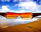 photo of a pair of sunglasses with beach view a natural way to prevent sun damage